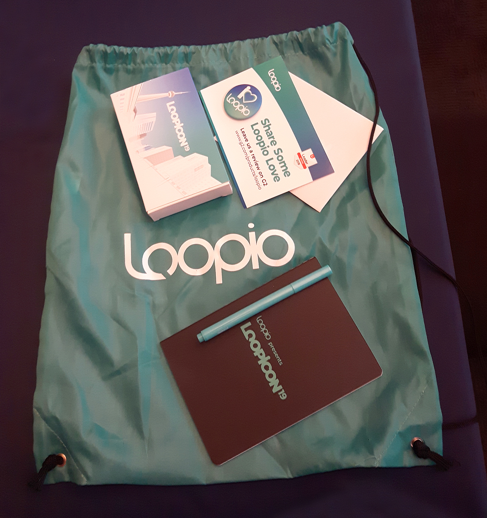 Various conference swag items laid out on a table